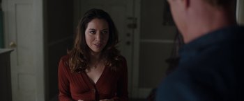 Movie still from “Child's Play” (2019), directed by Lars Klevberg – A beautiful woman in a red sweater looking at a mirror; Close Up shot, Over the shoulder angle