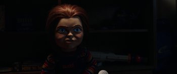 Movie still from “Child's Play” (2019), directed by Lars Klevberg – A chucky doll with blue eyes; Close Up shot, Over the shoulder angle