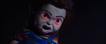Movie still from “Child's Play” (2019), directed by Lars Klevberg – A doll's face with red eyes; Close Up shot, Low angle