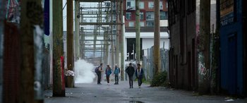 Movie still from “Child's Play” (2019), directed by Lars Klevberg – A group of people walking down a street; Extreme Wide shot, High angle