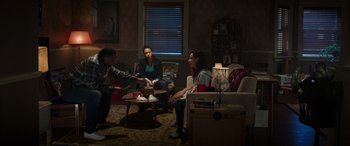 Movie still from “Child's Play” (2019), directed by Lars Klevberg – A group of people sitting in a living room; Wide shot, High angle