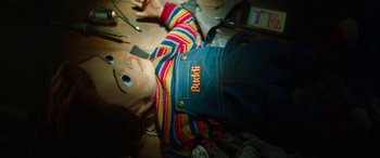 Movie still from “Child's Play” (2019), directed by Lars Klevberg – A child's play doll laying on the floor; Medium shot, Overhead angle