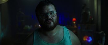 Movie still from “Child's Play” (2019), directed by Lars Klevberg – A man with a beard wearing glasses and a blue tank top; Close Up shot, Low angle