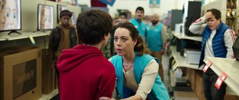 Movie still from “Child's Play” (2019), directed by Lars Klevberg – A woman is talking to a boy in a store; Medium shot, Over the shoulder angle