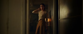 Movie still from “Child's Play” (2019), directed by Lars Klevberg – A woman standing in front of a mirror in a room; Medium shot, Low angle