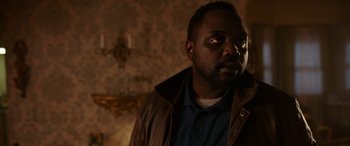 Movie still from “Child's Play” (2019), directed by Lars Klevberg – A man in a leather jacket looking to his left; Close Up shot, Over the shoulder angle