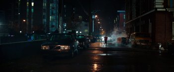 Movie still from “Child's Play” (2019), directed by Lars Klevberg – A person standing on the side of the street at night; Extreme Wide shot, High angle