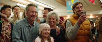 Movie still from “Child's Play” (2019), directed by Lars Klevberg – A group of adults and a child taking a picture; Medium shot, Over the shoulder angle