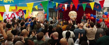 Movie still from “Child's Play” (2019), directed by Lars Klevberg – A crowd of people gathered in a room with masks on them; Wide shot, High angle