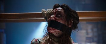 Movie still from “Child's Play” (2019), directed by Lars Klevberg – A woman tied up with a black ribbon with blood on her face; Close Up shot, High angle