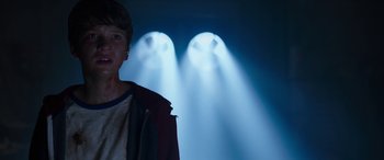 Movie still from “Child's Play” (2019), directed by Lars Klevberg – A man standing in front of a wall of lights; Close Up shot, Low angle