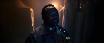 Movie still from “Child's Play” (2019), directed by Lars Klevberg – A man in a police uniform is looking at the camera; Close Up shot, Low angle