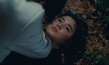 Movie still from “Chizuko's Younger Sister” (1991), directed by Nobuhiko Ôbayashi – A man laying on the ground looking up at the sky; Close Up shot, High angle