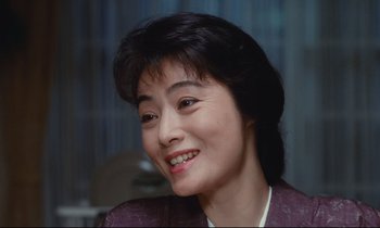 Movie still from “Chizuko's Younger Sister” (1991), directed by Nobuhiko Ôbayashi – A person with a smile on their face; Close Up shot, High angle