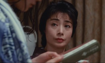 Movie still from “Chizuko's Younger Sister” (1991), directed by Nobuhiko Ôbayashi – A woman looking at her reflection in a mirror; Close Up shot, Over the shoulder angle