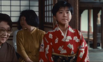 Movie still from “Chizuko's Younger Sister” (1991), directed by Nobuhiko Ôbayashi – A woman in a red and white kimono standing next to another woman in a yellow dress; Medium shot, Low angle