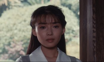 Movie still from “Chizuko's Younger Sister” (1991), directed by Nobuhiko Ôbayashi – A woman with long black hair wearing a white shirt; Close Up shot, Low angle