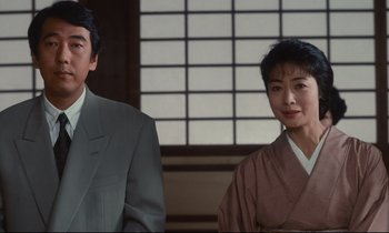 Movie still from “Chizuko's Younger Sister” (1991), directed by Nobuhiko Ôbayashi – A man and a woman standing next to each other; Medium shot, Low angle