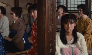 Movie still from “Chizuko's Younger Sister” (1991), directed by Nobuhiko Ôbayashi – A group of people sitting in a room; Medium shot, High angle