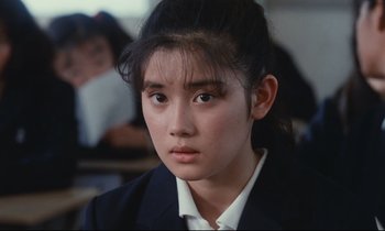 Movie still from “Chizuko's Younger Sister” (1991), directed by Nobuhiko Ôbayashi – A young woman in a black jacket and a white shirt; Close Up shot, High angle