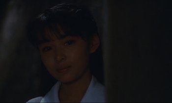 Movie still from “Chizuko's Younger Sister” (1991), directed by Nobuhiko Ôbayashi – A young man in a white shirt is looking at the camera; Close Up shot, Over the shoulder angle