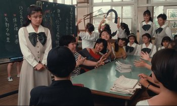 Movie still from “Chizuko's Younger Sister” (1991), directed by Nobuhiko Ôbayashi – A group of people sitting around a table; Medium shot, Over the shoulder angle