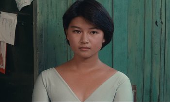 Movie still from “Chizuko's Younger Sister” (1991), directed by Nobuhiko Ôbayashi – A woman with short black hair wearing a white shirt; Close Up shot, High angle