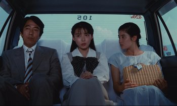 Movie still from “Chizuko's Younger Sister” (1991), directed by Nobuhiko Ôbayashi – A group of people sitting in a car; Medium shot, Over the shoulder angle