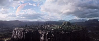 Movie still from “The Dark Tower” (2017), directed by Nikolaj Arcel – An image of an alien landscape with mountains in the background; Extreme Wide shot, High angle