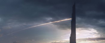 Movie still from “The Dark Tower” (2017), directed by Nikolaj Arcel – A streak of light is shown in the sky above a tall building; Extreme Wide shot, Low angle
