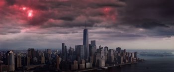 Movie still from “The Dark Tower” (2017), directed by Nikolaj Arcel – A view of a city skyline with a cloudy sky above it; Extreme Wide shot, High angle