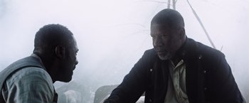 Movie still from “The Dark Tower” (2017), directed by Nikolaj Arcel – Two men are talking in a foggy area; Close Up shot, Over the shoulder angle