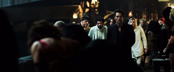 Movie still from “The Dark Tower” (2017), directed by Nikolaj Arcel – A group of men standing next to each other in a dark room; Medium shot, Low angle