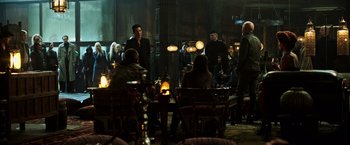Movie still from “The Dark Tower” (2017), directed by Nikolaj Arcel – A group of people sitting around a table; Wide shot, Over the shoulder angle