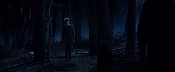Movie still from “The Dark Tower” (2017), directed by Nikolaj Arcel – A man standing in the woods at night; Wide shot, High angle