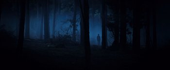Movie still from “The Dark Tower” (2017), directed by Nikolaj Arcel – A man standing in the middle of a forest at night; Extreme Wide shot, Low angle