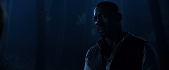 Movie still from “The Dark Tower” (2017), directed by Nikolaj Arcel – A man standing in the dark looking at the camera; Close Up shot, Over the shoulder angle
