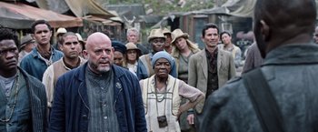 Movie still from “The Dark Tower” (2017), directed by Nikolaj Arcel – A group of people standing in the street; Medium shot, Over the shoulder angle