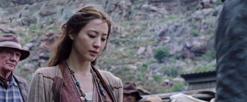 Movie still from “The Dark Tower” (2017), directed by Nikolaj Arcel – A young woman with long brown hair wearing a necklace; Close Up shot, Over the shoulder angle