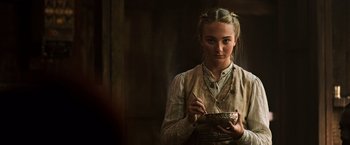 Movie still from “The Dark Tower” (2017), directed by Nikolaj Arcel – A woman holding a bowl in her hands; Close Up shot, Low angle