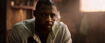 Movie still from “The Dark Tower” (2017), directed by Nikolaj Arcel – A man in a white shirt is looking to his left; Close Up shot, Low angle