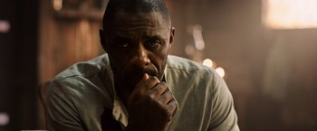 Movie still from “The Dark Tower” (2017), directed by Nikolaj Arcel – A man with his hand under his chin looking pensive; Close Up shot, Low angle
