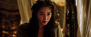 Movie still from “The Dark Tower” (2017), directed by Nikolaj Arcel – A woman with long black hair wearing a brown shirt; Close Up shot, Over the shoulder angle