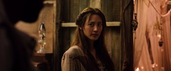 Movie still from “The Dark Tower” (2017), directed by Nikolaj Arcel – A woman with long brown hair wearing a crown; Close Up shot, Over the shoulder angle