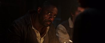 Movie still from “The Dark Tower” (2017), directed by Nikolaj Arcel – A man sitting in front of a lit candle; Close Up shot, Over the shoulder angle