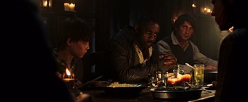Movie still from “The Dark Tower” (2017), directed by Nikolaj Arcel – A group of people sitting at a table with food; Medium shot, High angle