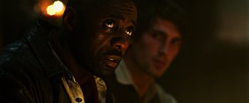 Movie still from “The Dark Tower” (2017), directed by Nikolaj Arcel – Two men sitting next to each other in a dark room; Close Up shot, Over the shoulder angle