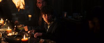 Movie still from “The Dark Tower” (2017), directed by Nikolaj Arcel – A man and a boy sitting at a dinner table; Medium shot, Over the shoulder angle