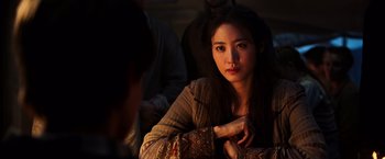 Movie still from “The Dark Tower” (2017), directed by Nikolaj Arcel – A woman sitting in front of a group of other people; Close Up shot, Over the shoulder angle