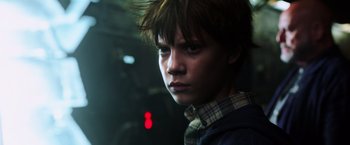 Movie still from “The Dark Tower” (2017), directed by Nikolaj Arcel – A young boy with a plaid shirt is looking at the camera; Close Up shot, Low angle